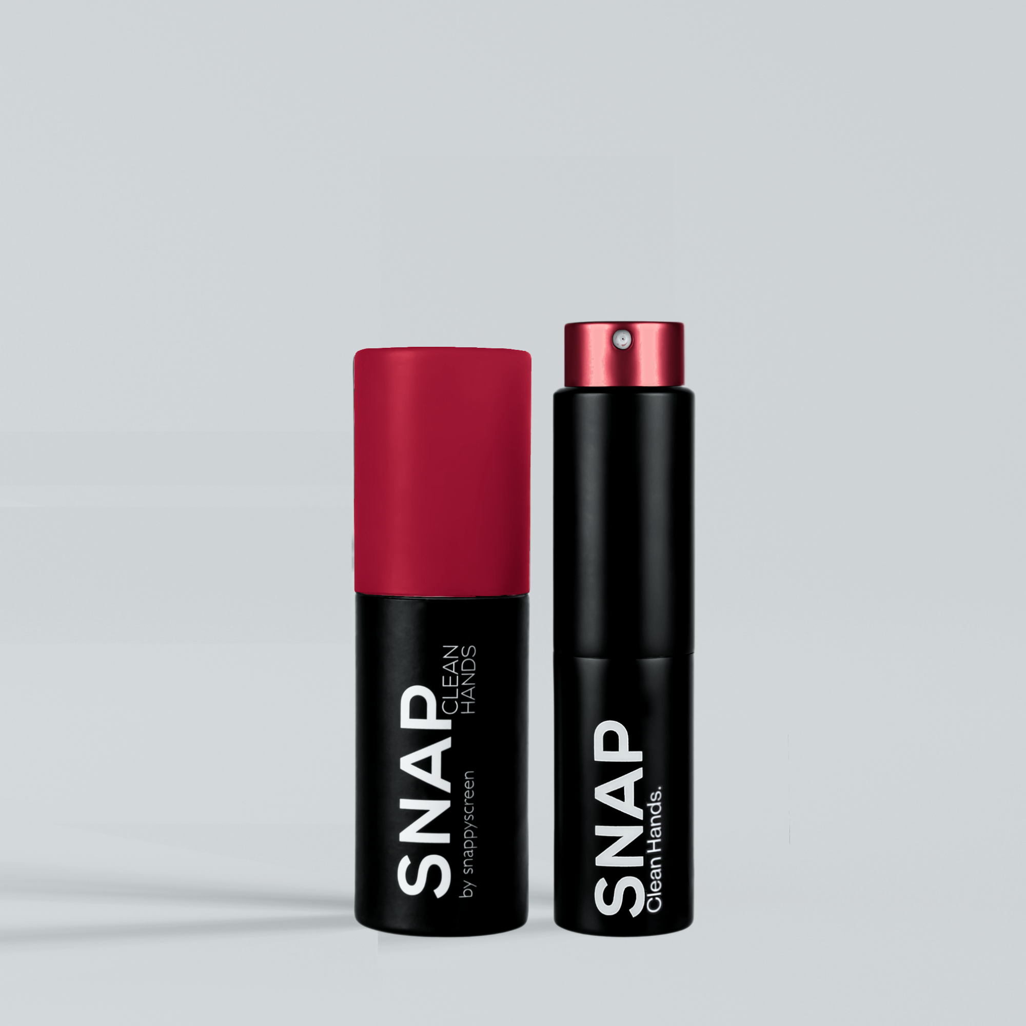 Two black SNAP hand sanitizer spray bottles on a light gray background.